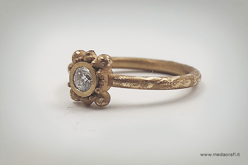 Anello solitario in oro giallo e gambo martellato